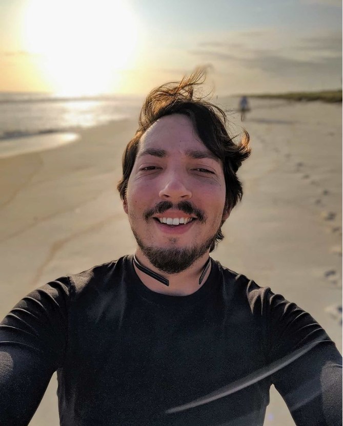 A man with a blue shirt smiling